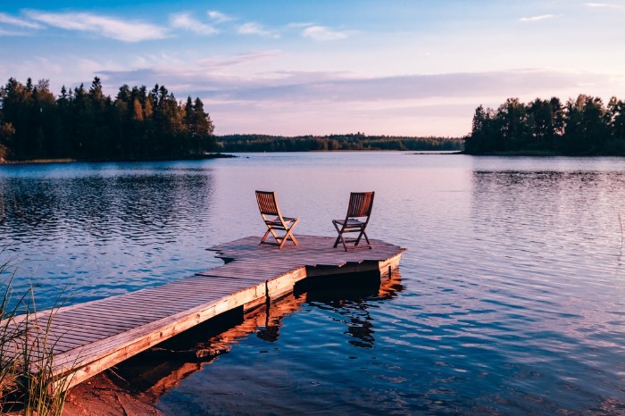 lake dock with 2 chairs